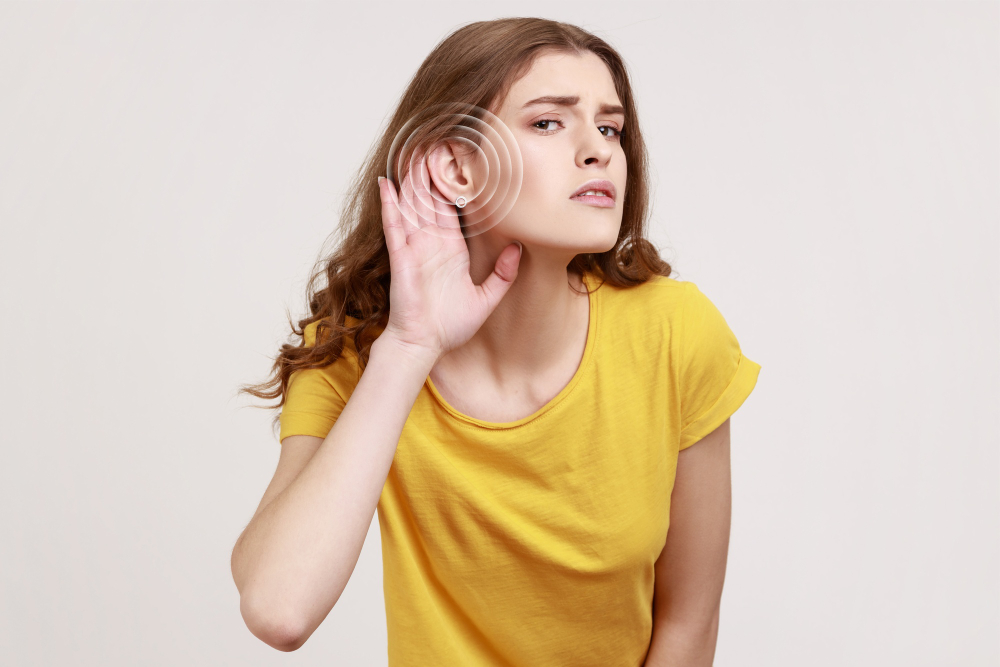 Woman straining to hear a faint sound